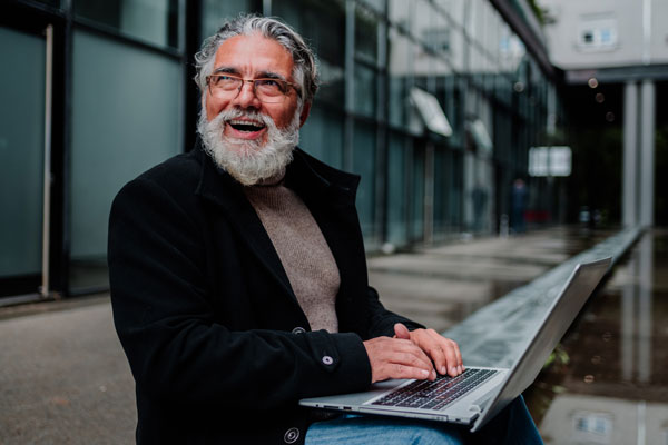 portrait of a senior businessman using laptop